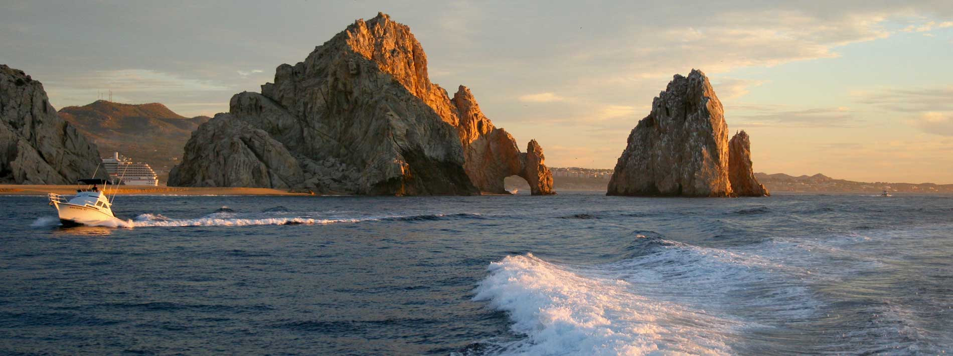 Fishing boats pass by Land's End in Cabo San Lucas